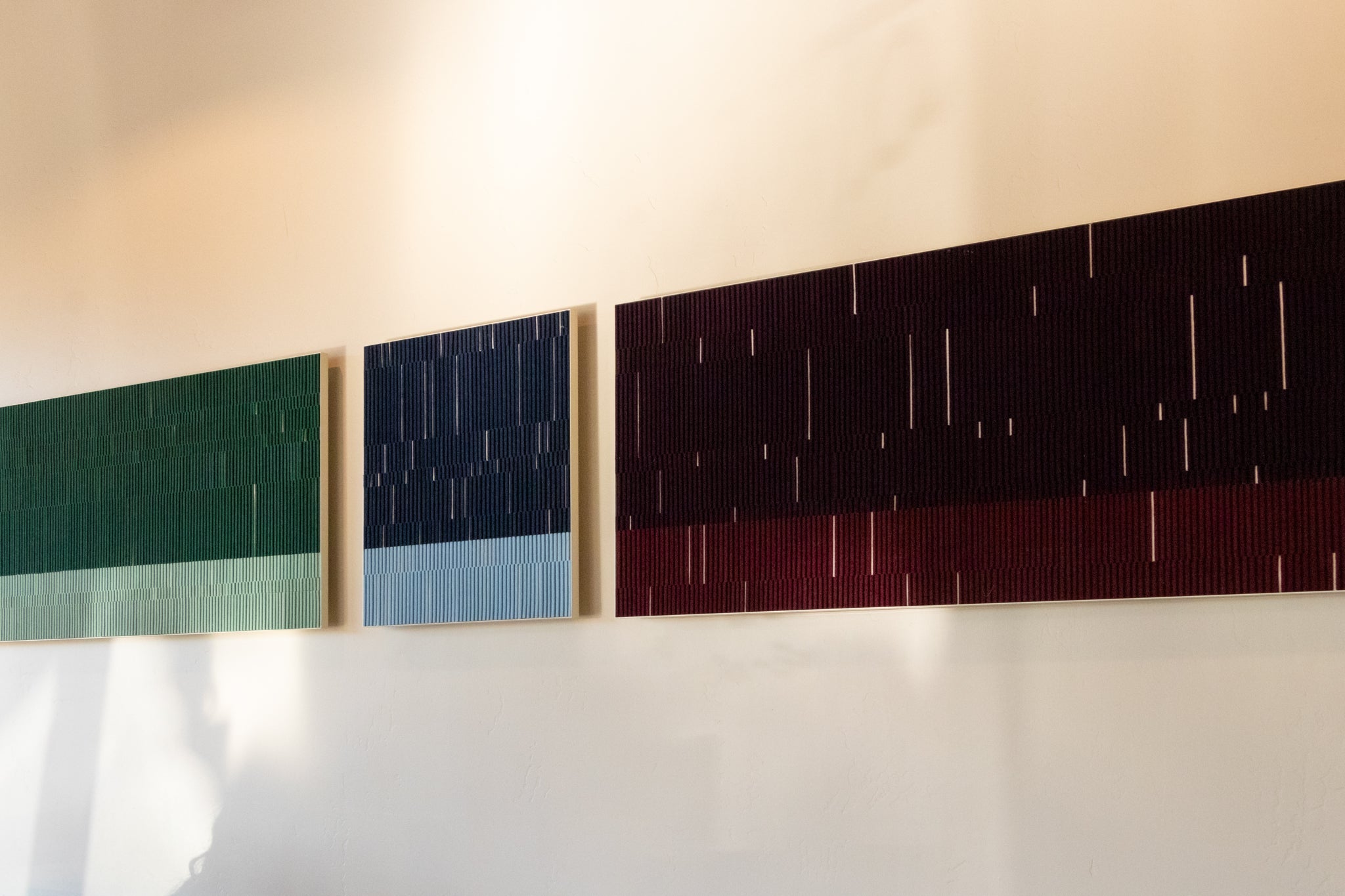 felt wall art in two ton reds, blues, and greens
