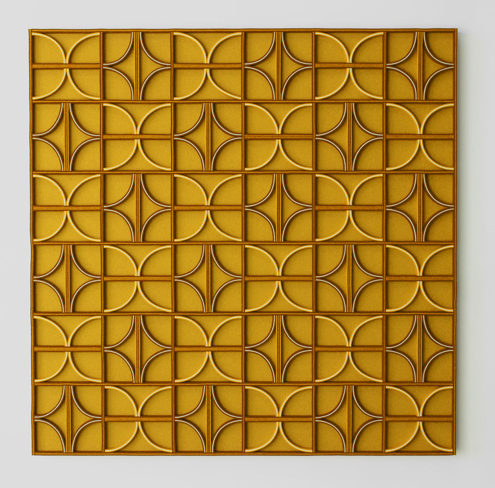 A square felt wall panel in tones of yellow, white, and brown. The dimensional patter is straight lines and half and quarter circles.