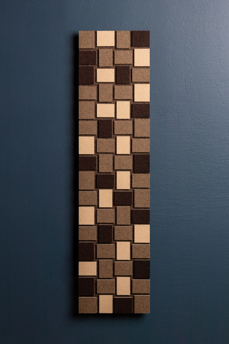 A long, thin vertical Odessa Flat panel with a geometric pattern of slight rectangles in beige and brown tones, presented against a dark blue background.