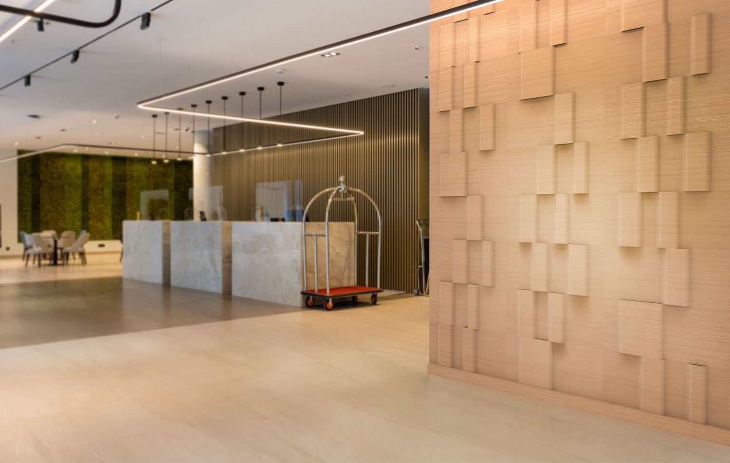 Modern hospitality interior with a reception desk and a decorative dimensional wood wall.