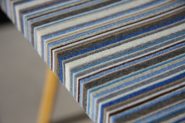 Closeup of a Myth wall Panel with strips of felt in blues, grays, and browns