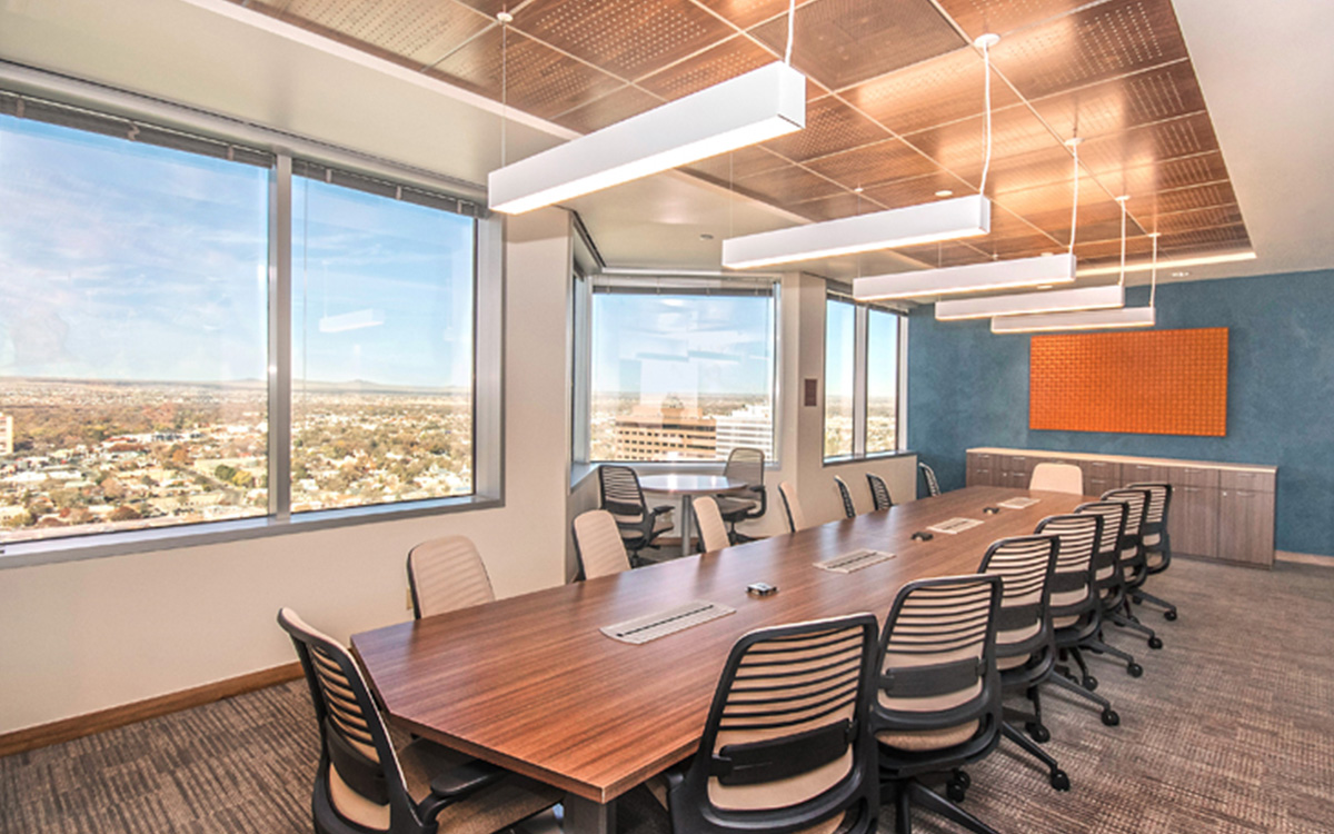 Orange Odessa Wall panel installed on a blue wall in a conference room with a bank of large windows