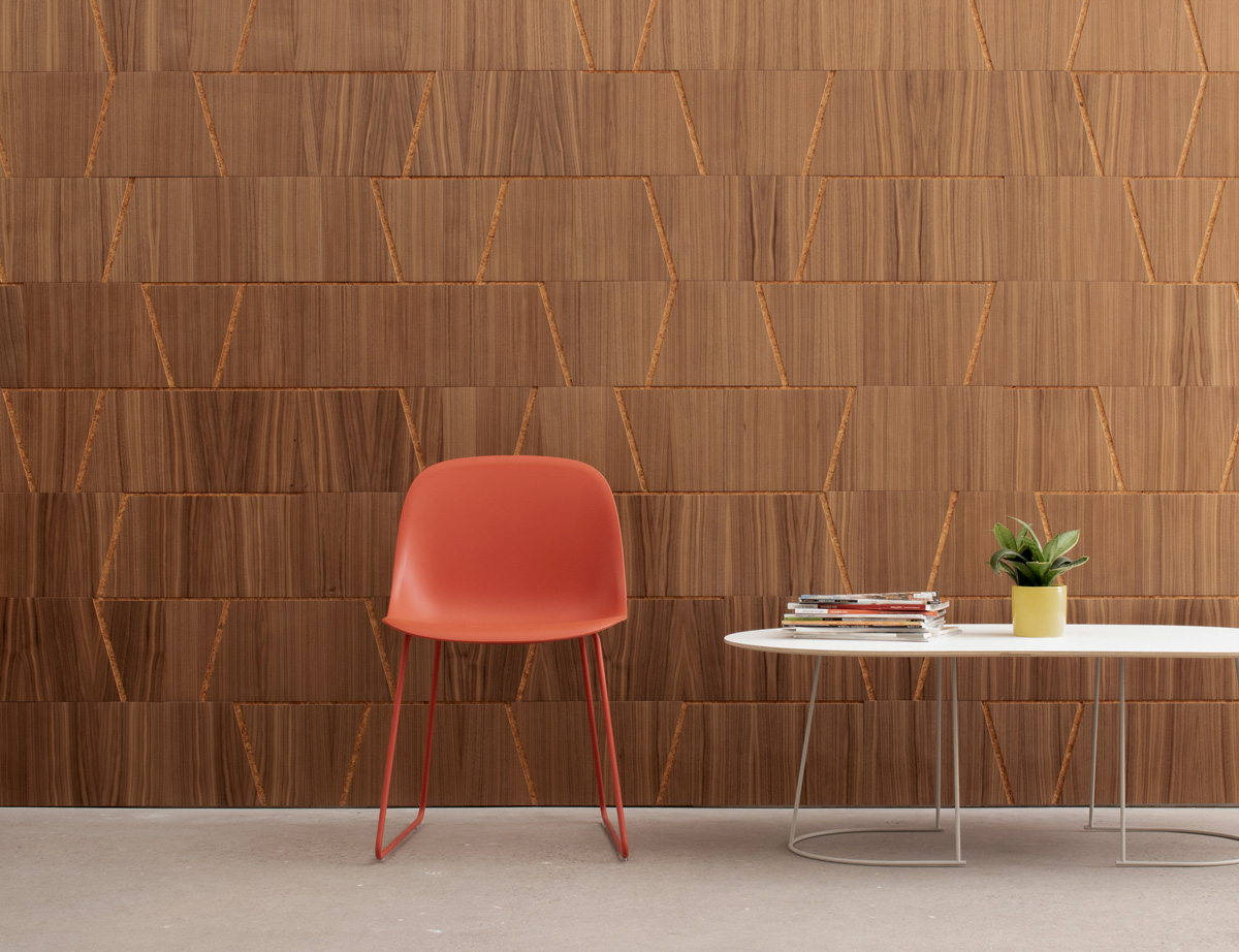 Wood wall covering in walnut and cork with notched out angled lines in an office setting