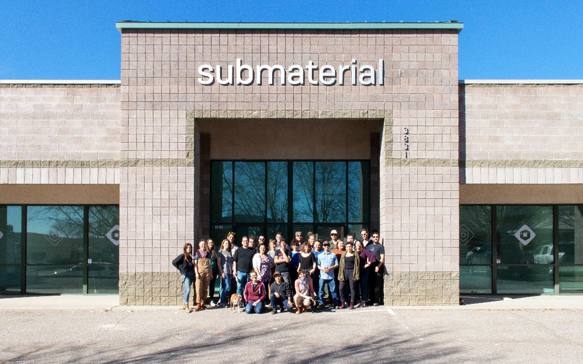 Submaterial staff in front of the building
