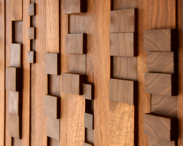 closeup of a decorative wall panel made of squares and rectangles of walnut wood
