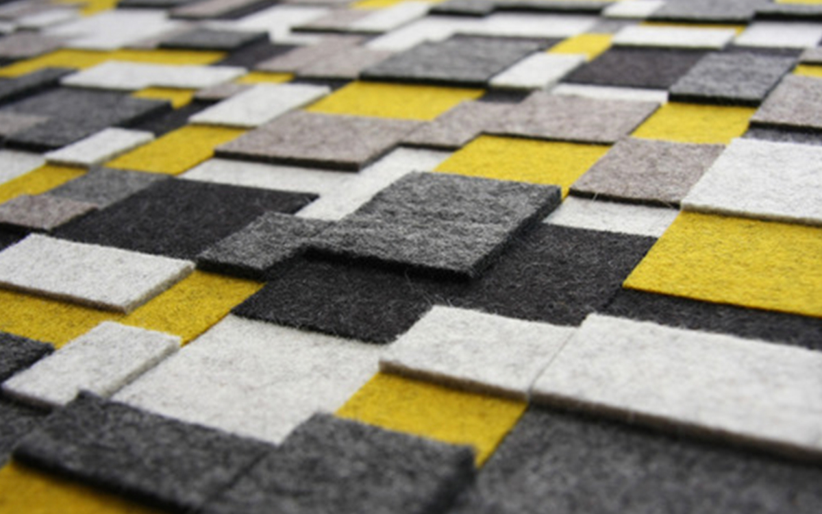 Closeup of square and rectangle felt pieces in white, gray, yellow, and black.