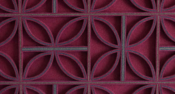 Extreme closeup of wine colored felt panel with straight lines and leaf shape details
