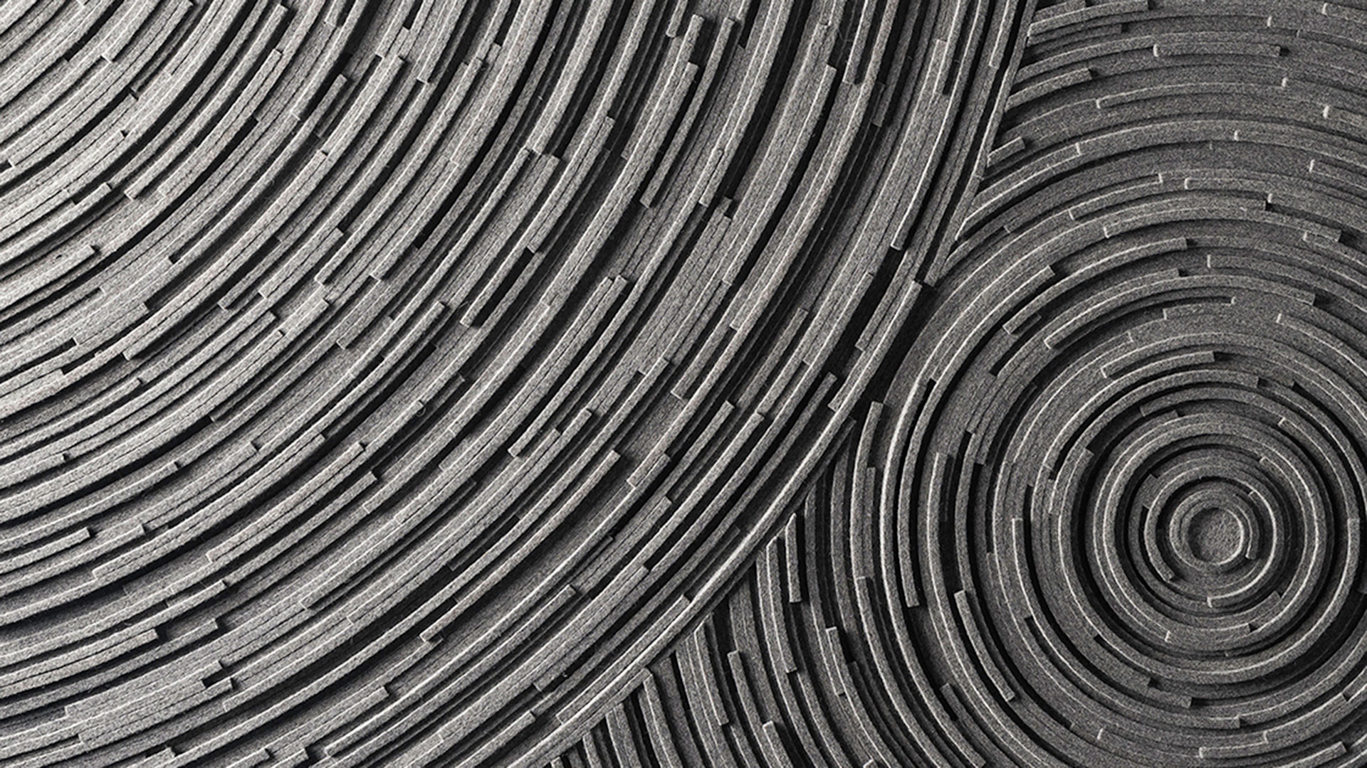 Closeup of circular gray felt on edge design details a Submaterial custom wall covering