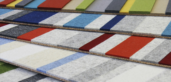 Sheets of colorblocked felt in grays, blues, and reds attached to a cork backing.