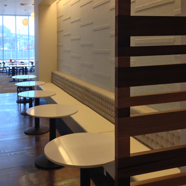A restaurant with custom white felt wallcovering