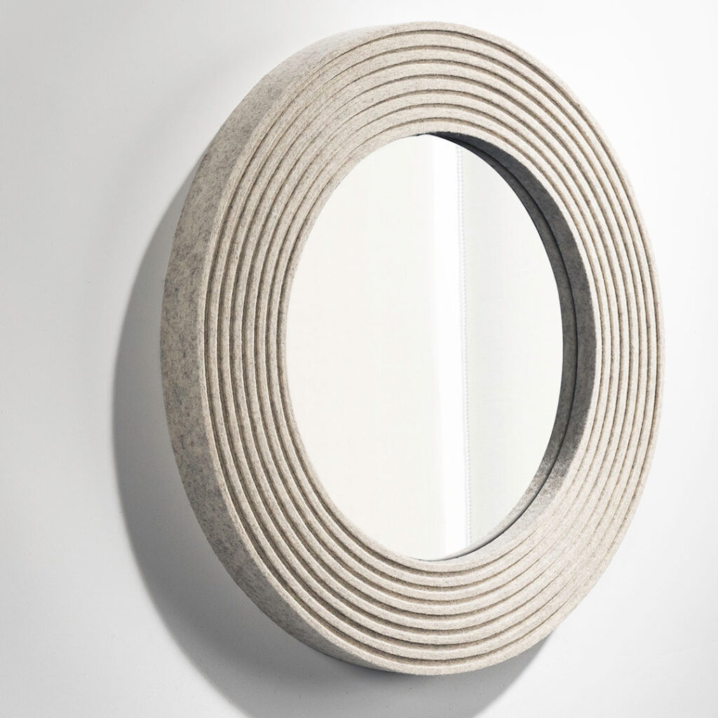 Circular mirror framed with heathered white ribbed felt