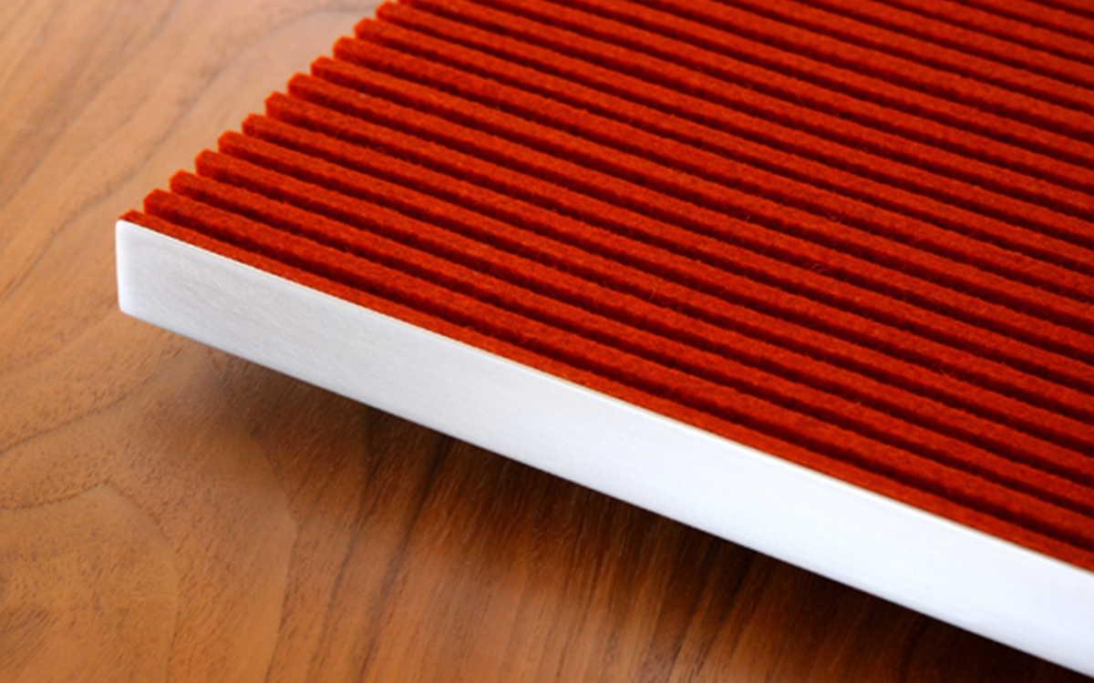 Red felt ribbed wall panel with white metal frame