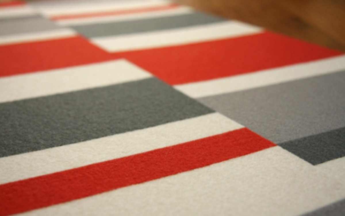 Closeup of white, red, and gray colorblocked felt