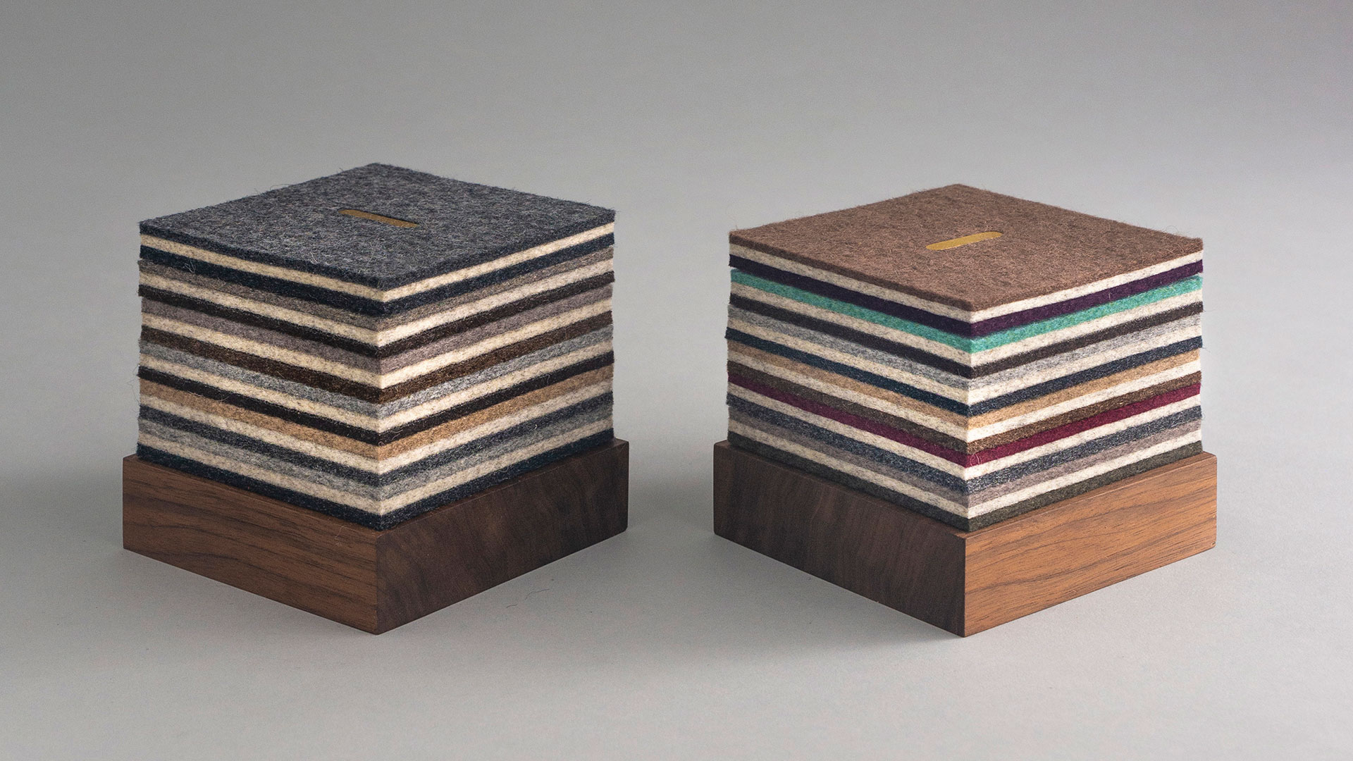 Two coaster sets with dark wood bases and layered multicolor felt square coasters