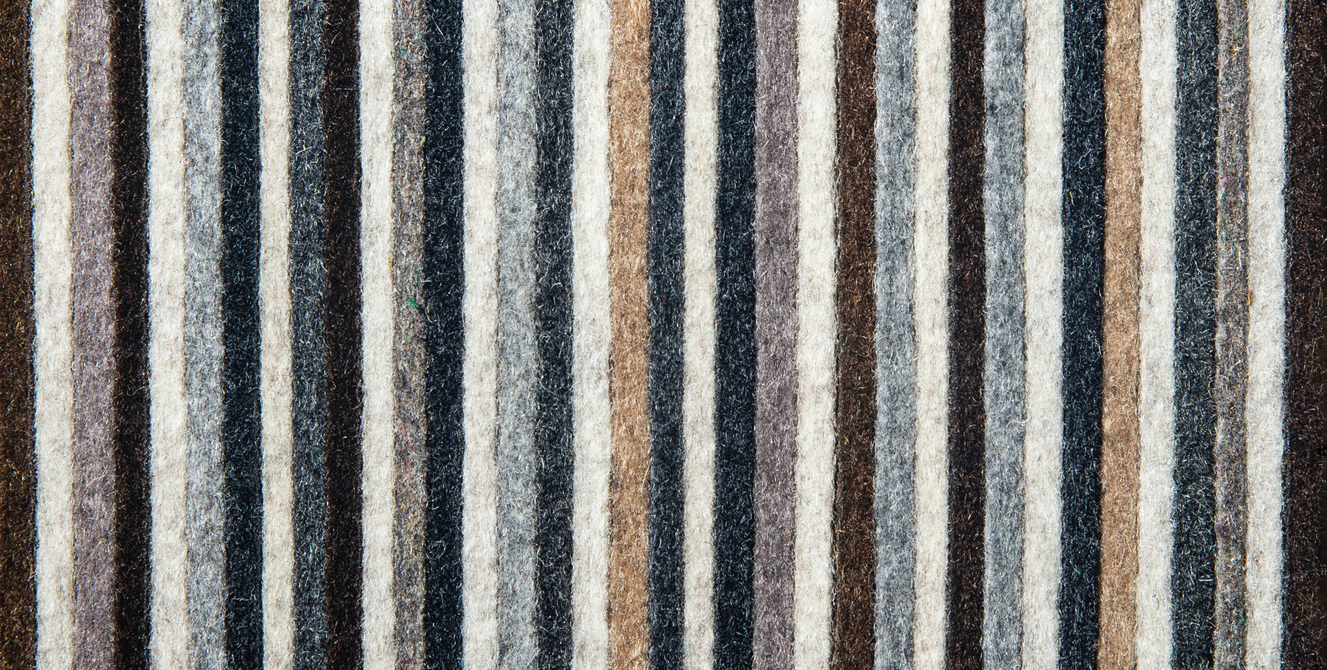 Closeup of felt strips in browns and grays and the word Road Runner