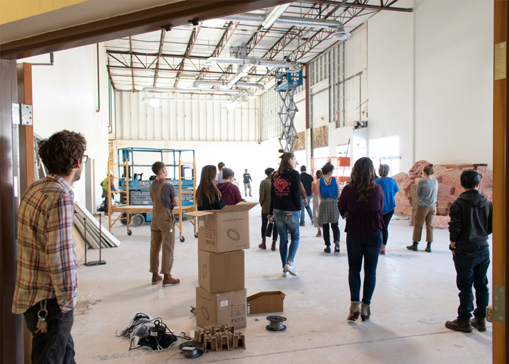 A group of people in a large space under construction