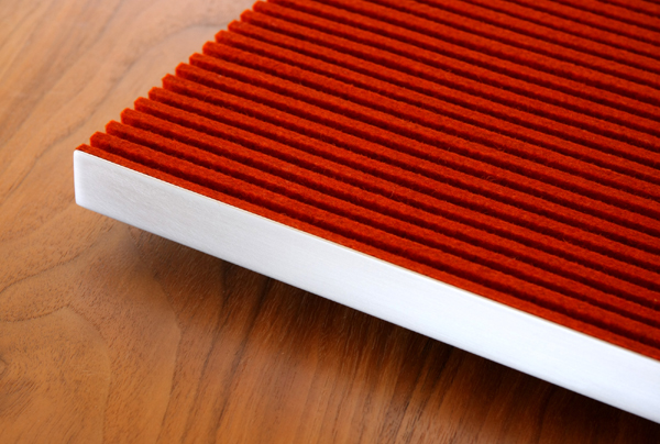 Red felt ribbed wall panel with white metal frame