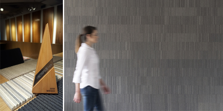 Two image, at left an triangular shaped wood award. At right is a women blurred by motion as she walks in front of a gray ribbed wallcovering