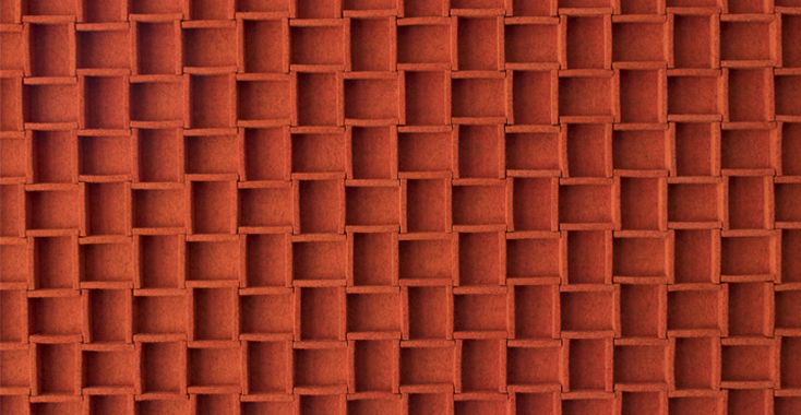Closeup of orange felt panel with grid pattern