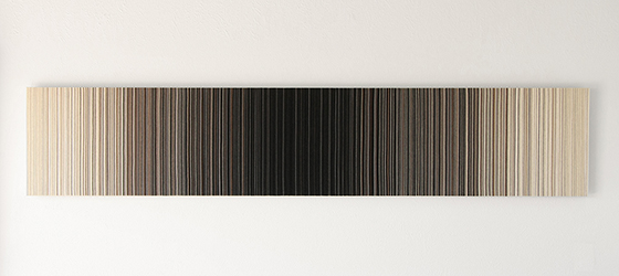 An elongated wall panel with gradient colors from dark in the middle to light on the edges.