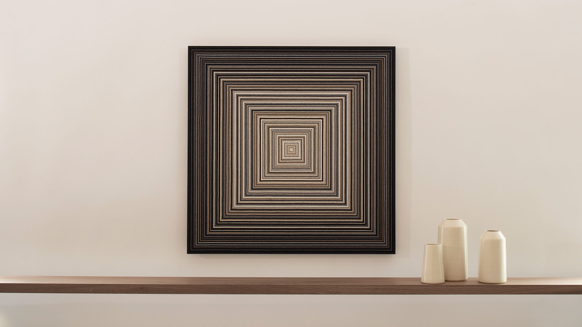 Square felt wall panel with concentric square lines in browns and grays.