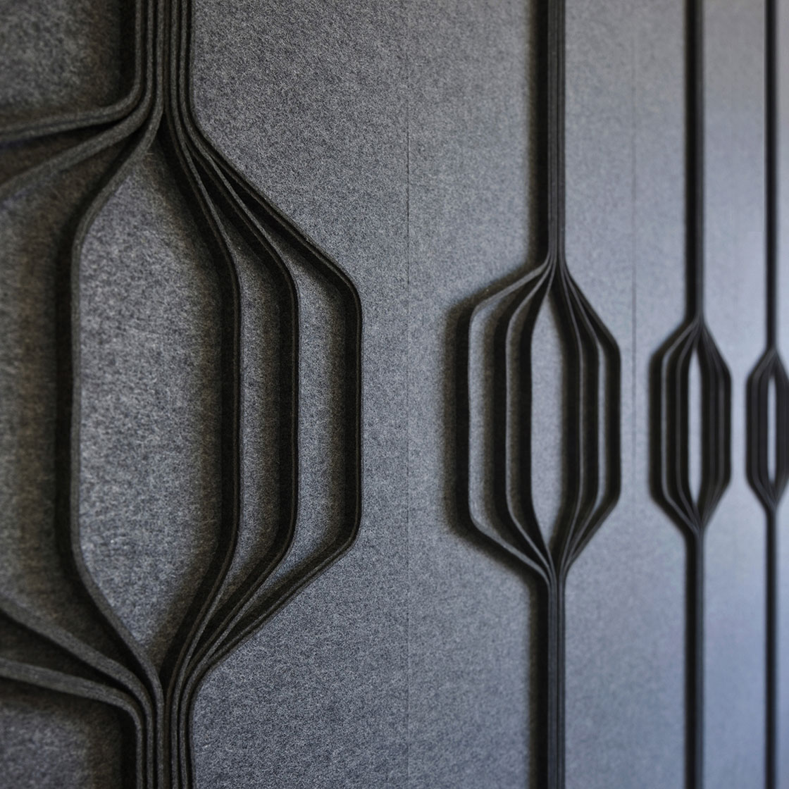 Closeup of dark gray wall covering with hexagonal shapes
