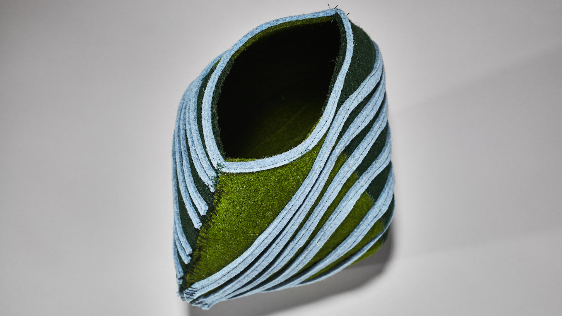 felt vessel made in pastel blue and dark green made by artist molly zimmer out of manufacturing byproducts