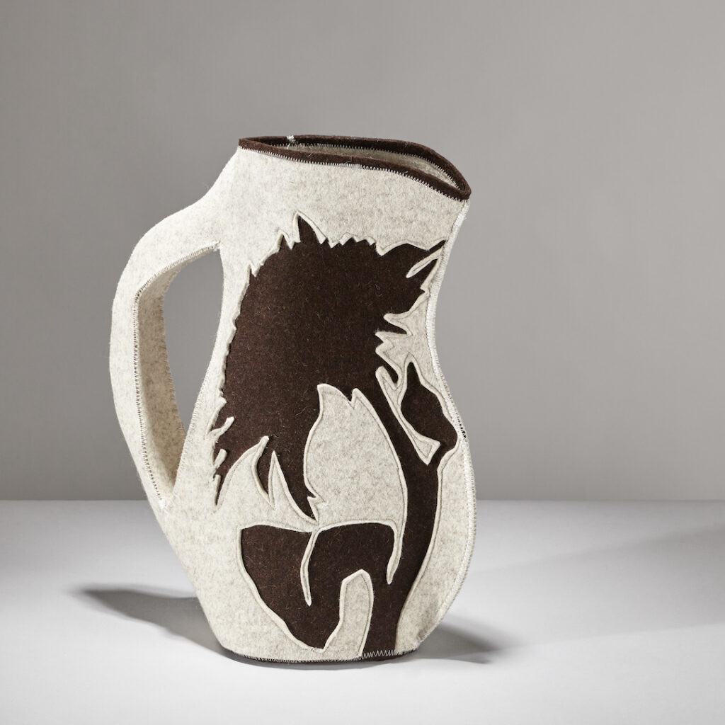 pitcher made of grey and brown felt featuring a silhouette of a sunflower