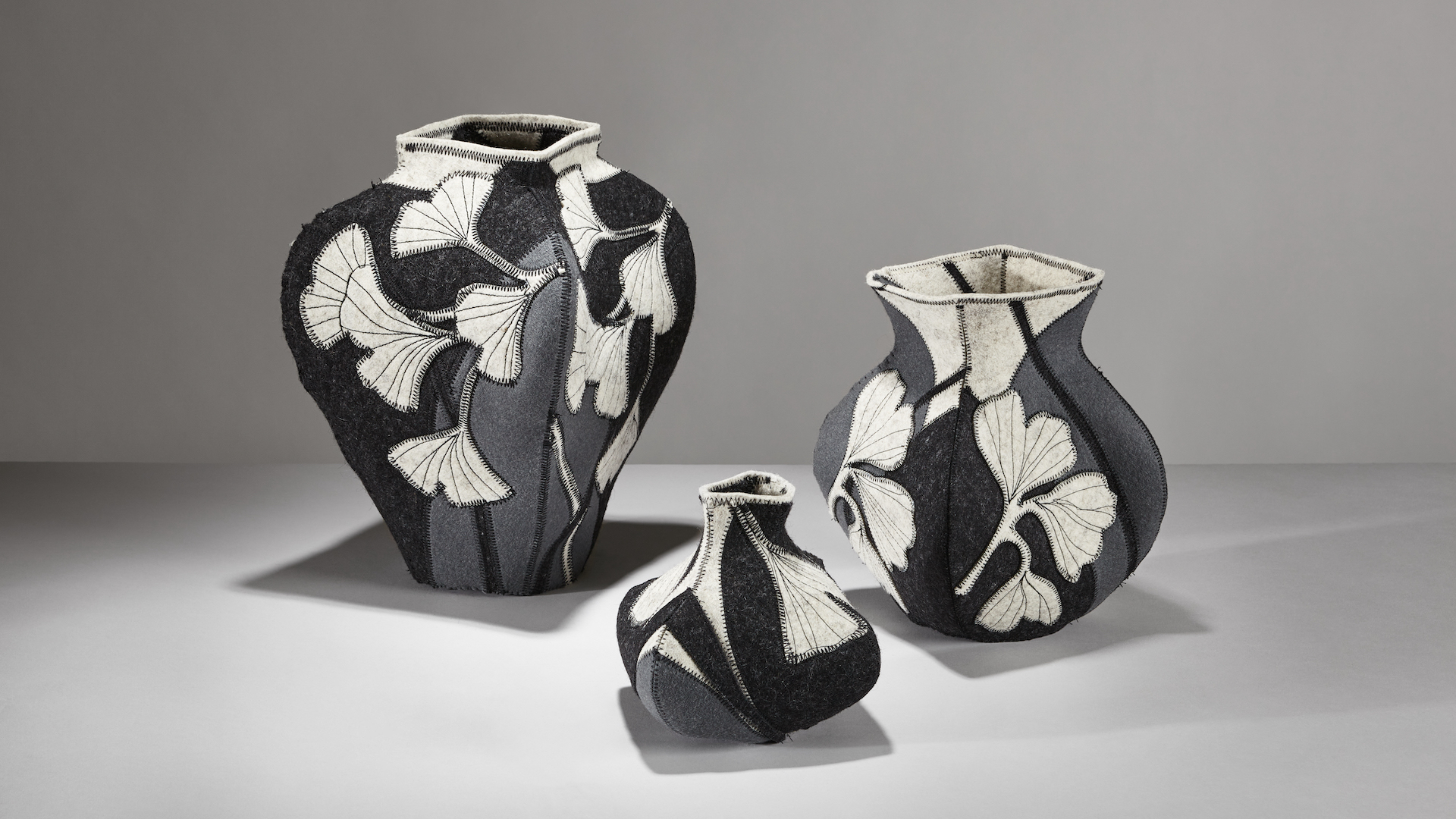 trio of sewn felt vases in shades of gray with a ginkgo leaf pattern by artist molly zimmer