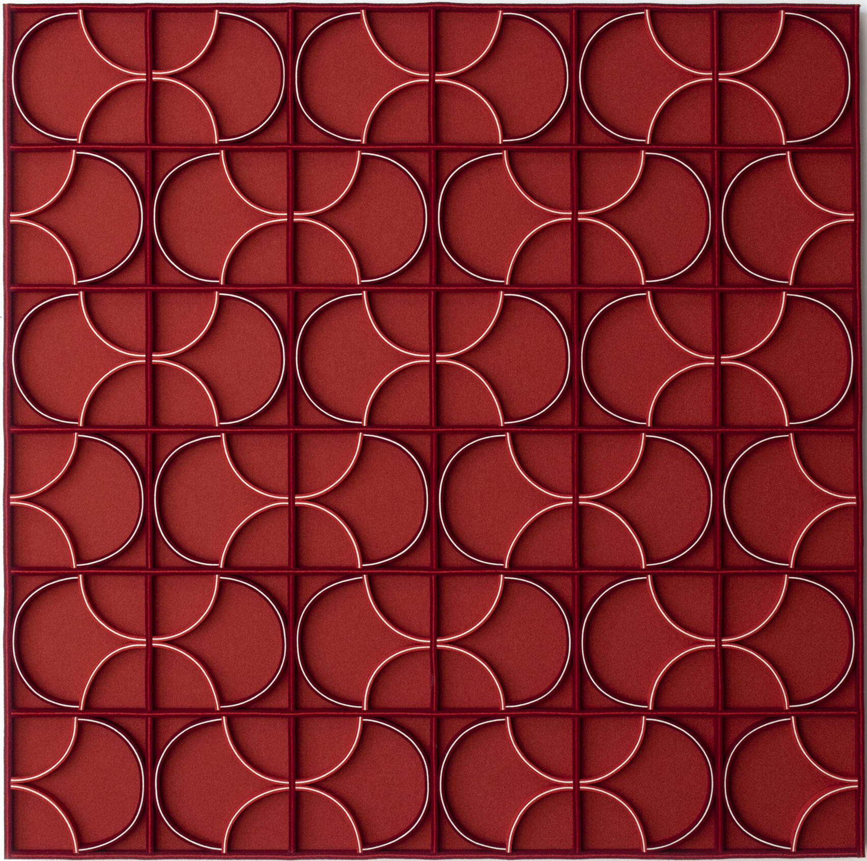 A red square wall panel with curved forms in square boxes with blue and white details