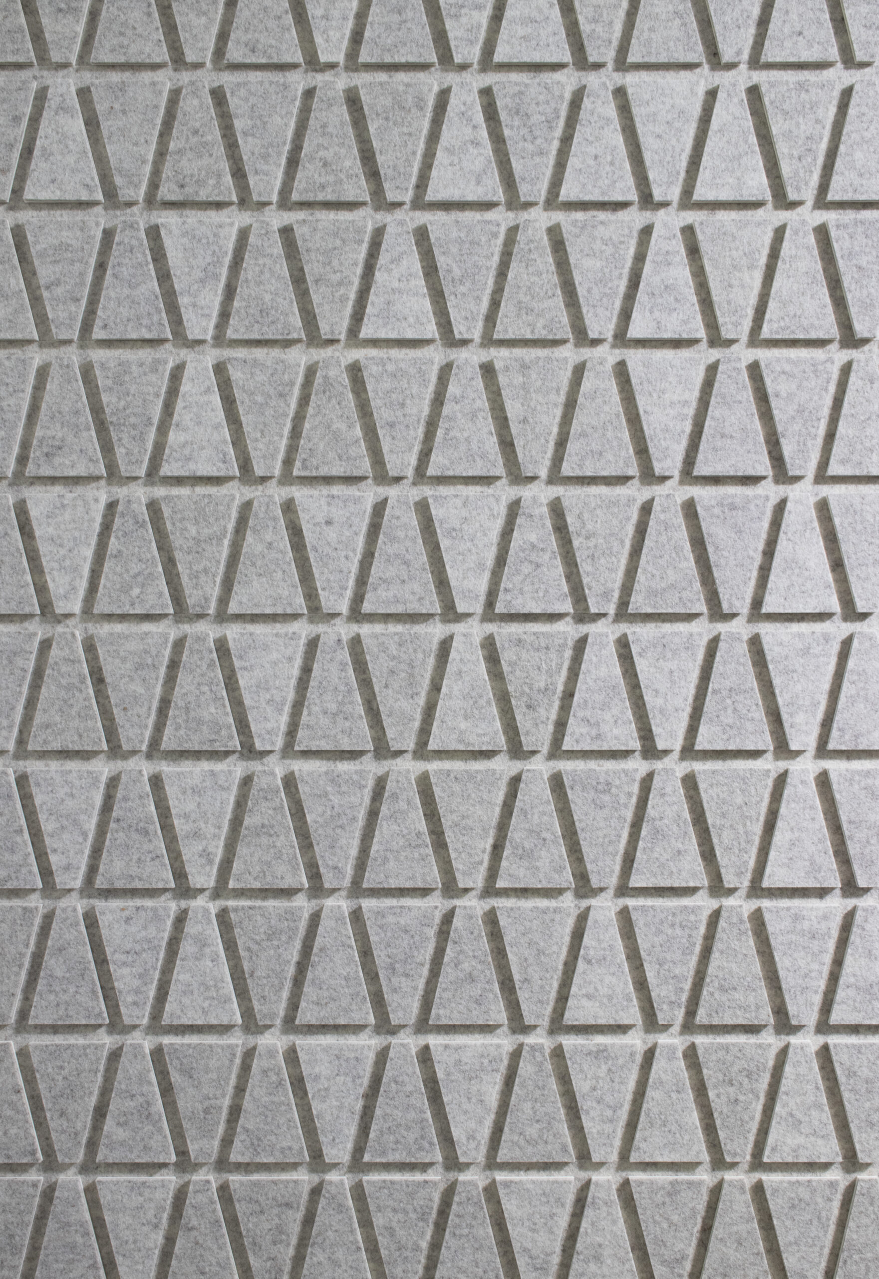 Closeup of circular gray felt on edge design details a Submaterial custom wall covering